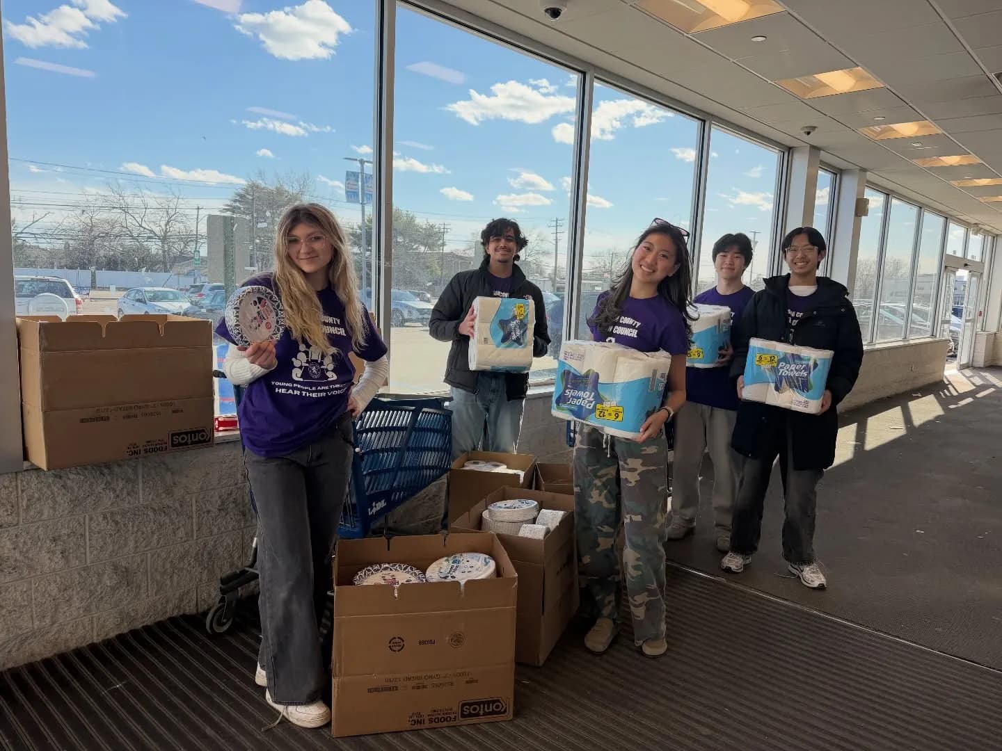 Volunteers holding donated kitchen supplies